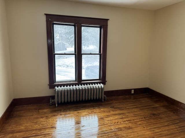 76 Center St, Richford, VT 05476 - spare room featuring radiator, wood finished floors, and plenty of natural light