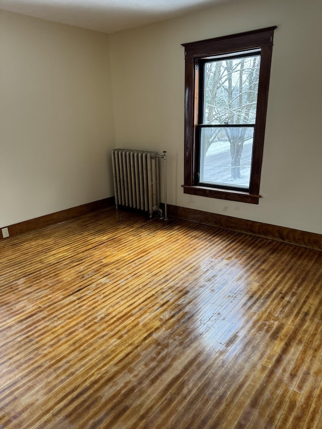 76 Center St, Richford, VT 05476 - unfurnished room with radiator heating unit and wood finished floors