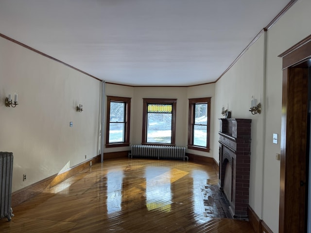 76 Center St, Richford, VT 05476 - unfurnished living room with radiator heating unit, a fireplace, hardwood / wood-style flooring, and crown molding