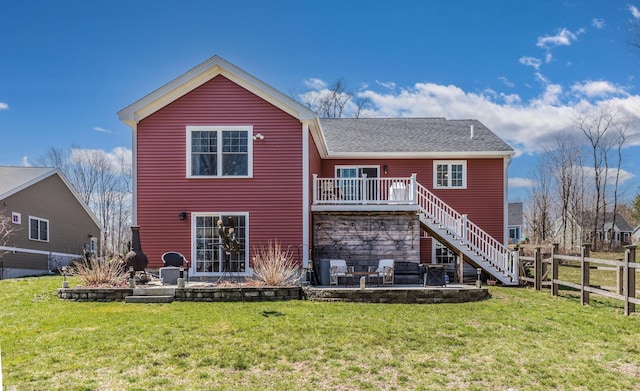 back of property with a patio area, stairs, and a shingled roof