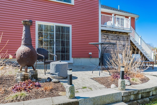 view of home's exterior with stairs and a patio area