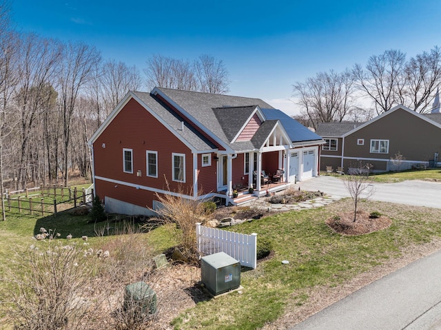 view of front of home with a shingled roof, concrete driveway, an attached garage, and a porch