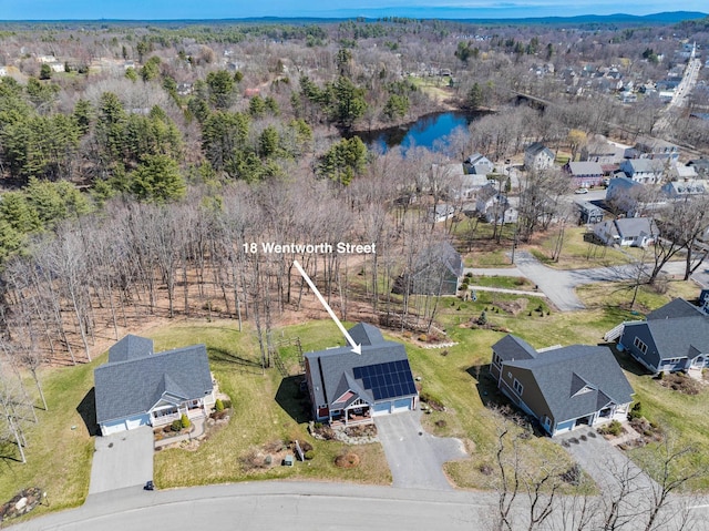 aerial view of property and surrounding area featuring a nearby body of water and nearby suburban area