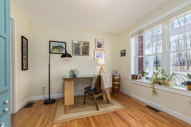 office area with light wood-style flooring and baseboards