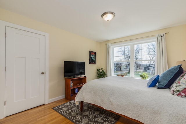 bedroom featuring wood finished floors and baseboards