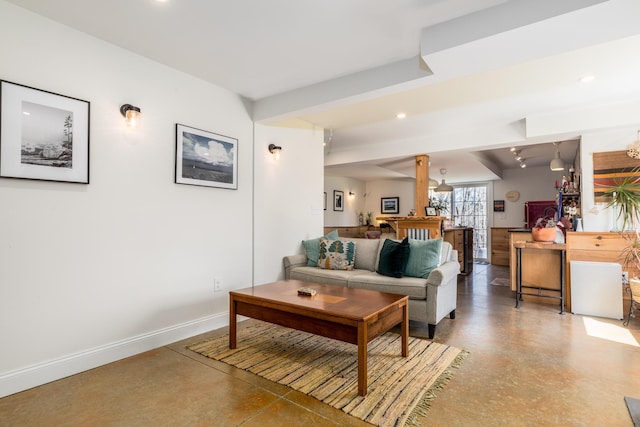 living room featuring baseboards, recessed lighting, and concrete floors