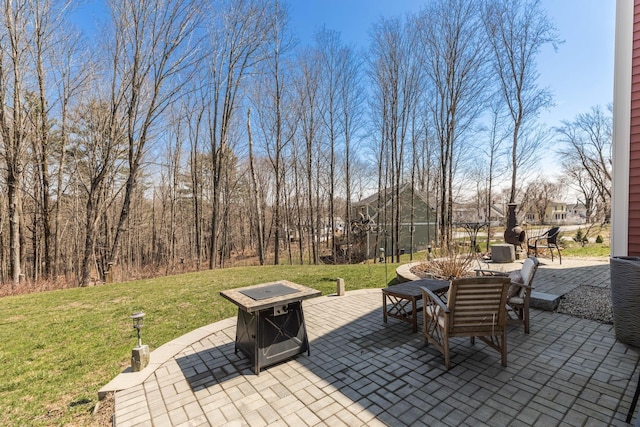 view of patio with a fire pit and outdoor dining area