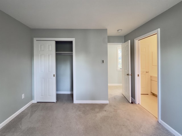 unfurnished bedroom with carpet, baseboards, and a closet