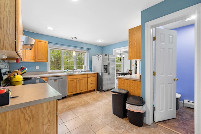 kitchen featuring stainless steel appliances, a baseboard radiator, wall chimney range hood, a sink, and light tile patterned floors