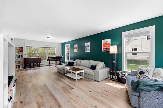 living room with light wood-type flooring and a baseboard radiator