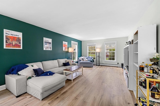 living area featuring light wood finished floors and a baseboard heating unit