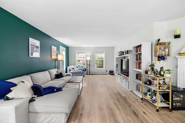 living room featuring light wood-style floors and baseboard heating