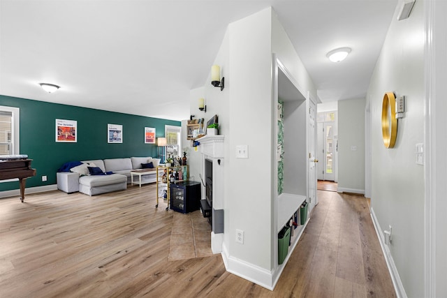 hall with wood finished floors and baseboards