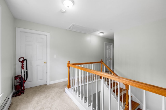 hallway featuring attic access, baseboard heating, carpet, an upstairs landing, and baseboards
