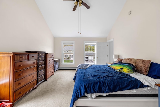 bedroom with vaulted ceiling, light colored carpet, a baseboard heating unit, and ceiling fan