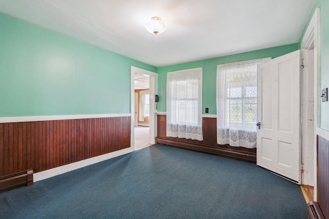 491 Brook Rd, Goshen, NH 03752 - empty room with wainscoting and a baseboard radiator