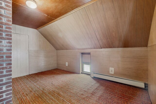 491 Brook Rd, Goshen, NH 03752 - bonus room featuring a baseboard radiator, lofted ceiling, carpet floors, and wood walls
