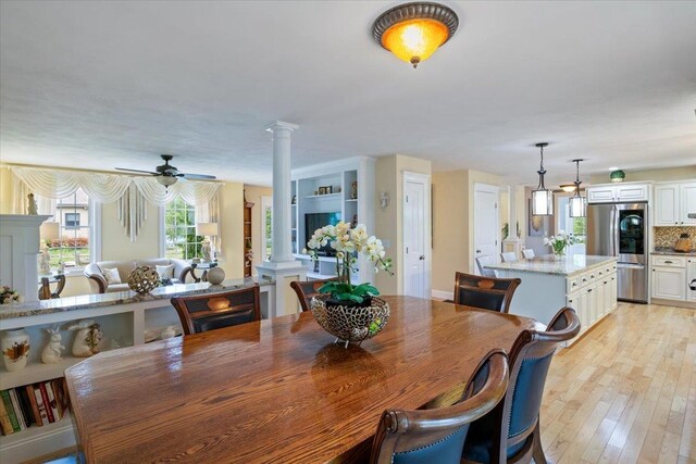 34 Coles Pond Rd, Somersworth, NH 03878 - dining room with ornate columns, light wood-type flooring, and ceiling fan