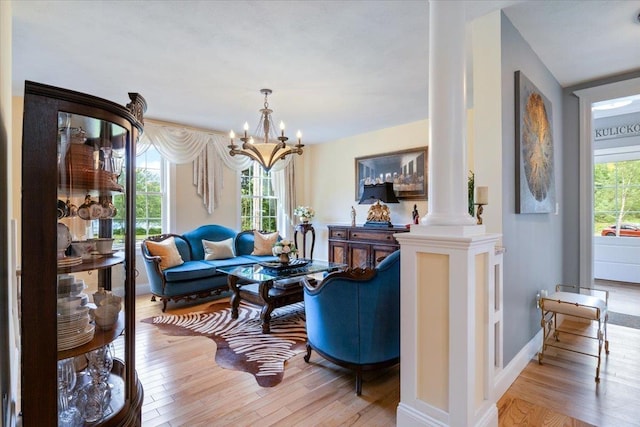 34 Coles Pond Rd, Somersworth, NH 03878 - living room with ornate columns, wood finished floors, a chandelier, and baseboards