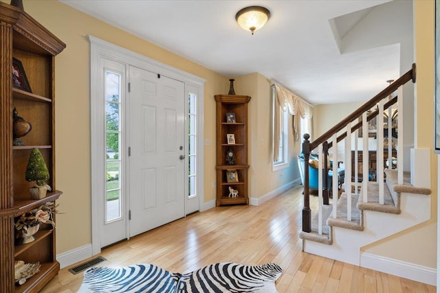 34 Coles Pond Rd, Somersworth, NH 03878 - foyer entrance with stairway, light wood-type flooring, and baseboards