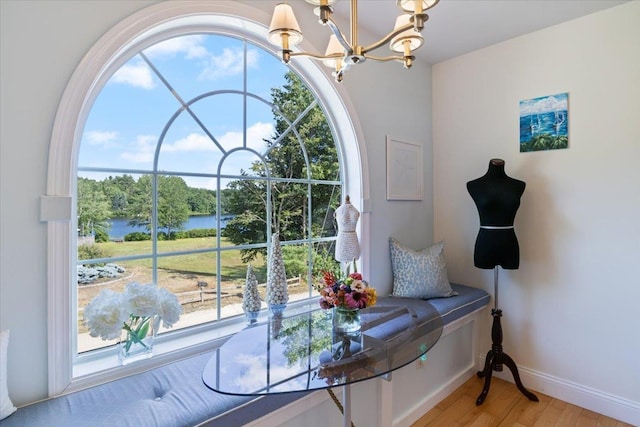 34 Coles Pond Rd, Somersworth, NH 03878 - living area featuring a chandelier, light wood finished floors, a water view, and baseboards