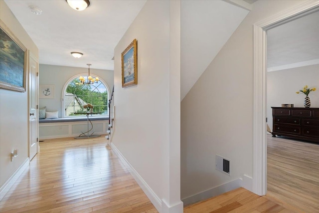 34 Coles Pond Rd, Somersworth, NH 03878 - hallway featuring a chandelier, light wood-type flooring, and baseboards