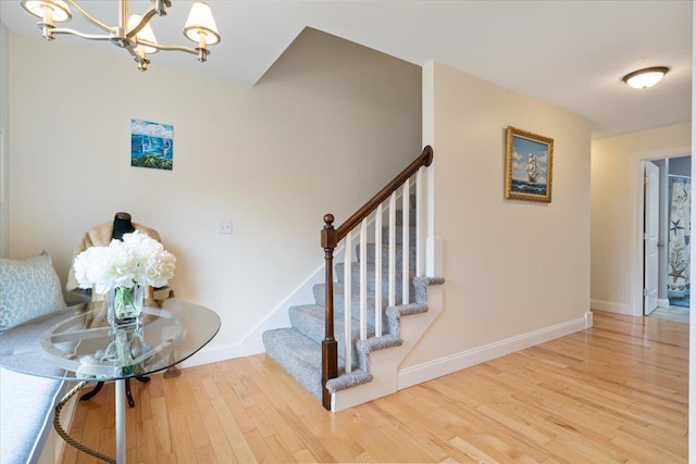34 Coles Pond Rd, Somersworth, NH 03878 - stairway with a chandelier, wood finished floors, and baseboards