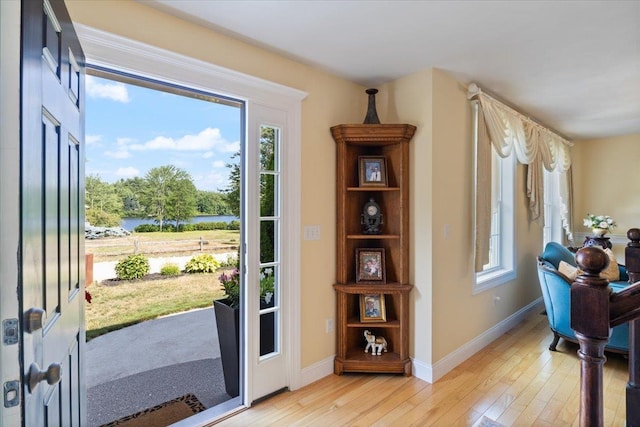 34 Coles Pond Rd, Somersworth, NH 03878 - entryway featuring light wood-type flooring, baseboards, and a water view