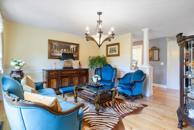 34 Coles Pond Rd, Somersworth, NH 03878 - living room with decorative columns, wood finished floors, and a chandelier