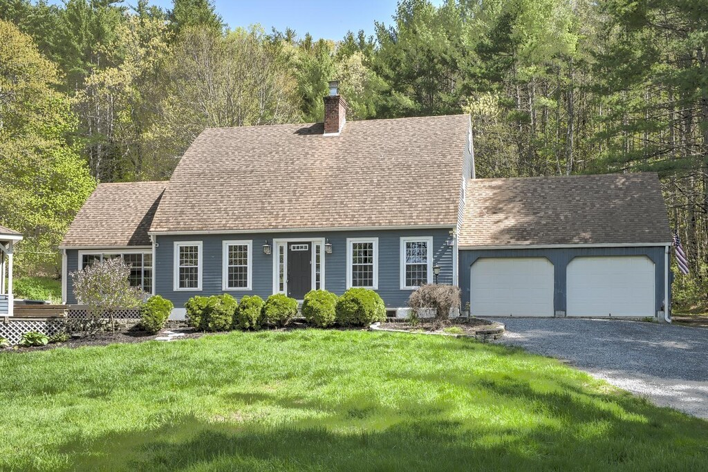 267 Swanzey Lake Rd, Swanzey, NH 03446 - cape cod home with a chimney, a shingled roof, an attached garage, a front lawn, and driveway