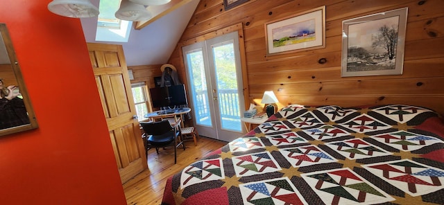 573 Granite Lake Rd, Nelson, NH 03457 - bedroom with lofted ceiling, wooden walls, access to outside, light wood-style flooring, and a skylight