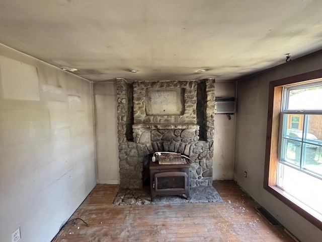 311 Clinton St, Concord, NH 03301 - living room with a wood stove and an AC wall unit
