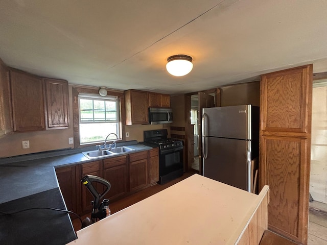 311 Clinton St, Concord, NH 03301 - kitchen featuring appliances with stainless steel finishes, a sink, and brown cabinets