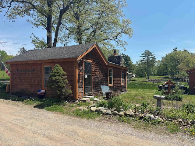 311 Clinton St, Concord, NH 03301 - view of side of home with a chimney, roof with shingles, and fence