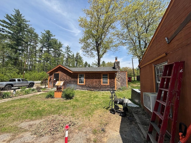 311 Clinton St, Concord, NH 03301 - view of front of home with a chimney and a front lawn