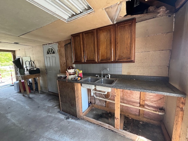 311 Clinton St, Concord, NH 03301 - kitchen with a sink, dark countertops, unfinished concrete flooring, and dark brown cabinets
