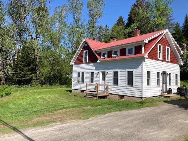 1413 Main St, Pittsburg, NH 03592 - view of front of property with a chimney and a front lawn