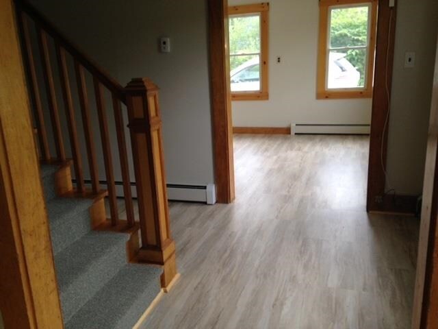 1413 Main St, Pittsburg, NH 03592 - stairway with a baseboard heating unit, wood finished floors, and baseboards