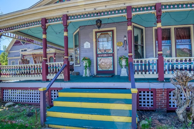 view of exterior entry with covered porch