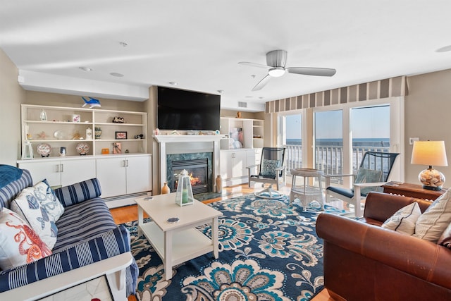 605 Ocean Blvd Unit 1, Hampton, NH 03842 - living room with a baseboard radiator, ceiling fan, a high end fireplace, and wood finished floors