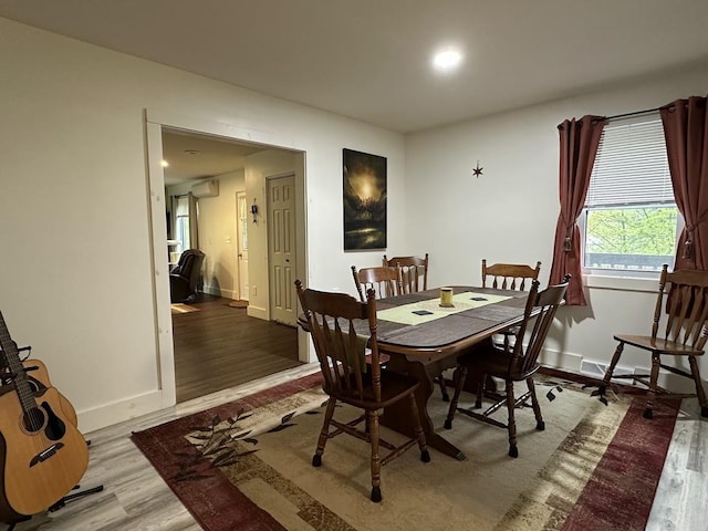 dining space with wood finished floors, baseboards, and recessed lighting