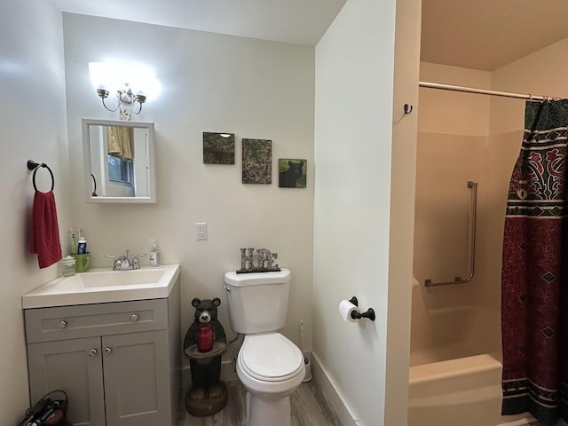 full bathroom with toilet, baseboards, vanity, and wood finished floors