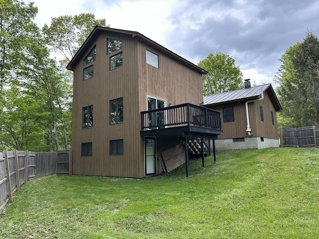 rear view of house with a wooden deck, stairs, a chimney, and metal roof
