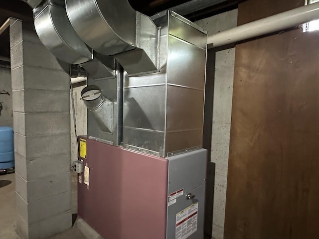 utility room featuring heating unit