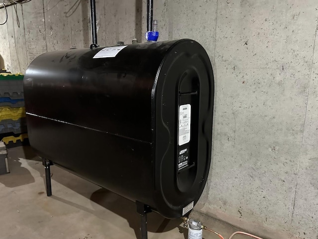 basement view of heating fuel and concrete floors