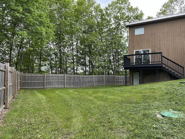 view of yard with a deck and stairway