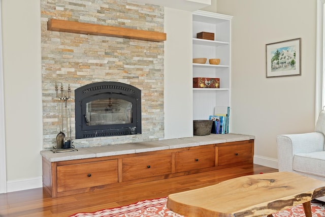 7 Timberbrook N, Dorset, VT 05251 - living room with baseboards, wood finished floors, a glass covered fireplace, and built in shelves
