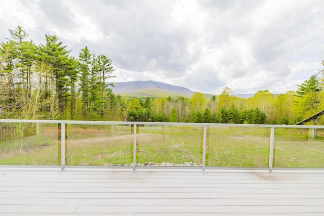 7 Timberbrook N, Dorset, VT 05251 - deck with a wooded view, a mountain view, and a lawn