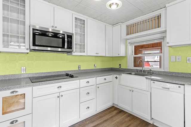 552 Dix St, Manchester, NH 03103 - kitchen with white dishwasher, stainless steel microwave, black electric cooktop, a sink, and white cabinetry
