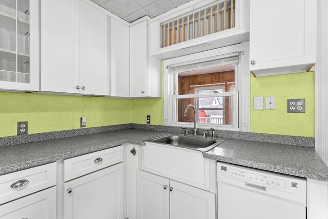 552 Dix St, Manchester, NH 03103 - kitchen with dishwasher, a sink, and white cabinetry